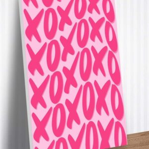 a pink canvas with the letters xo and yo on it sitting on a wooden table